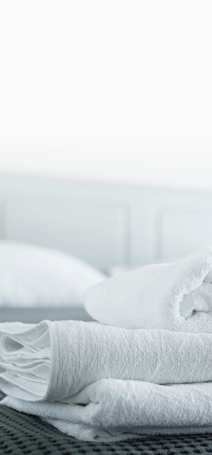 High End Commercial Linen Laundry Services A folded pile of freshly cleaned linens.